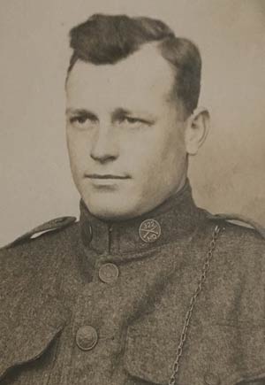 Black and white portrait of a young white man in uniform.