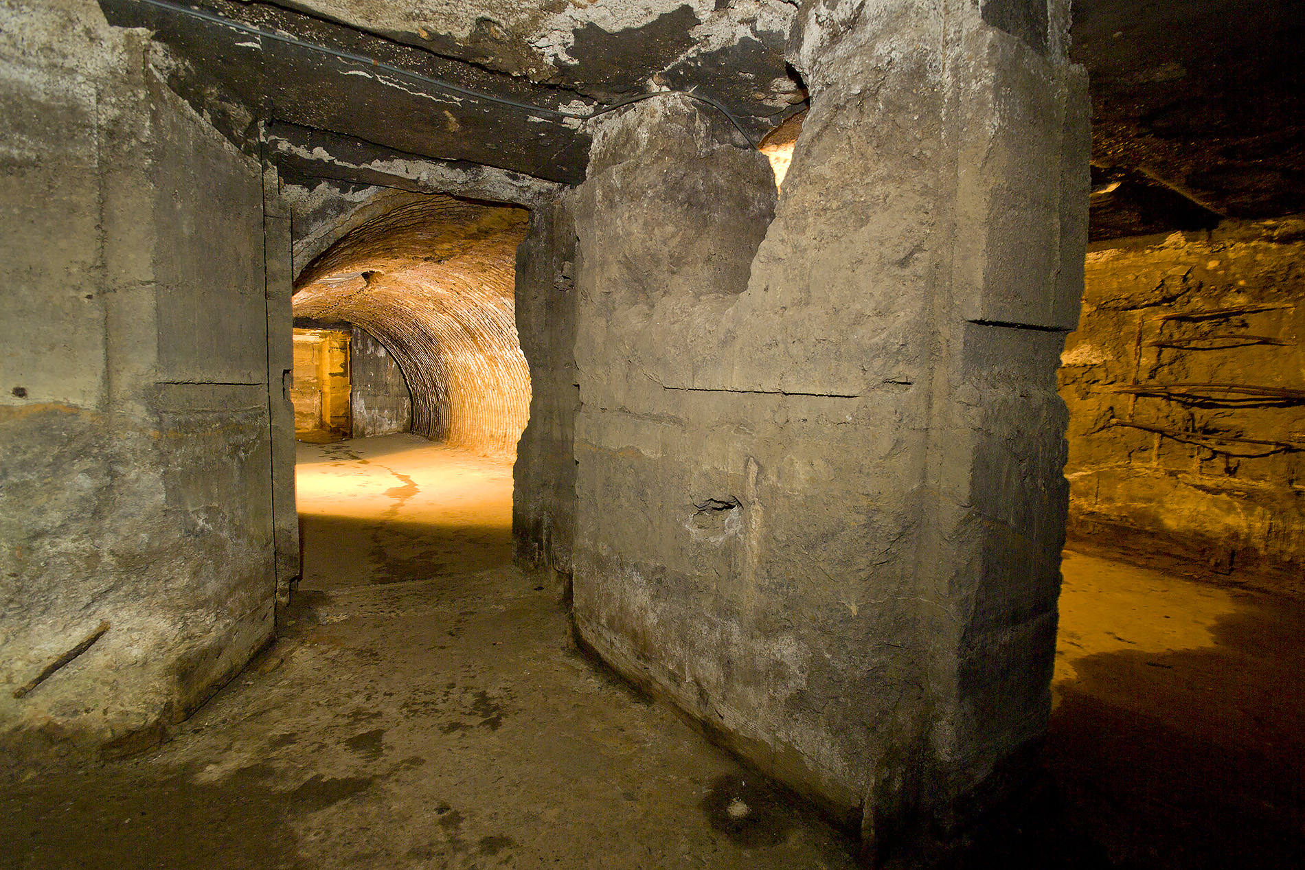 Modern photograph from inside the crumbled remains of a concrete underground bunker.