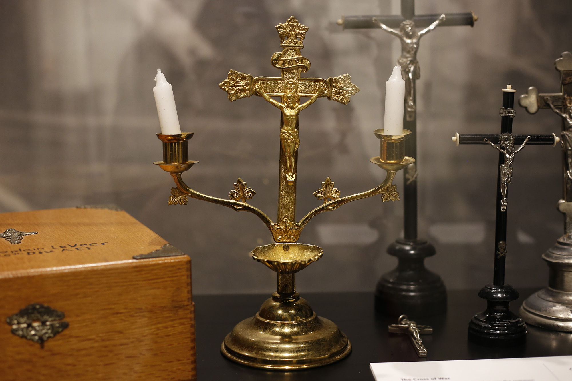 Modern photograph of a gold crucifix with two branches for candlesticks.