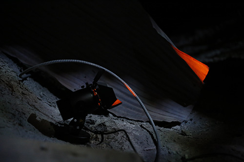 Modern photograph of a small special effect spotlight nestled in the midst of a lifesize battlescape diorama