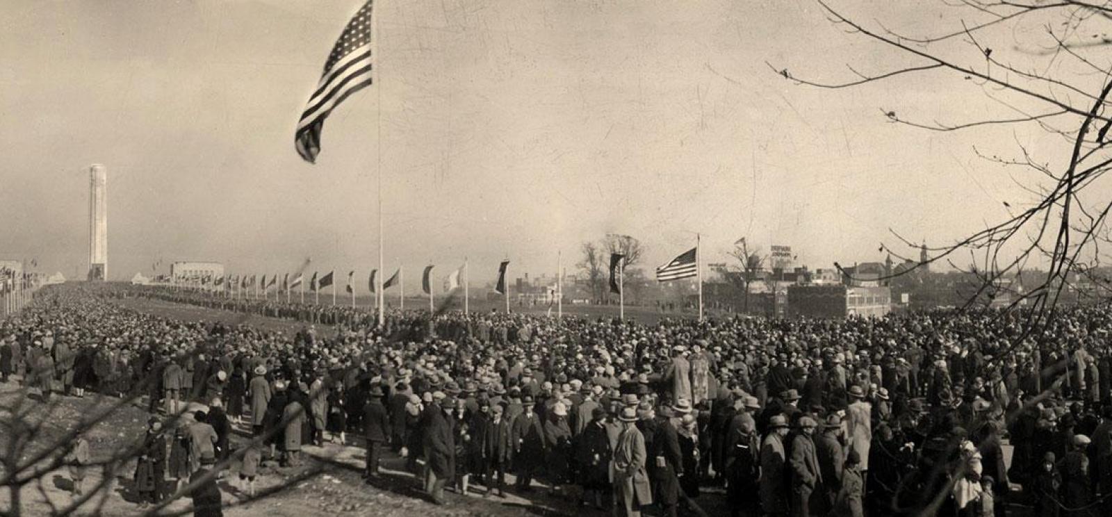 Sepia picture of a large crowd of people filling the mall in front of the Liberty Memorial.