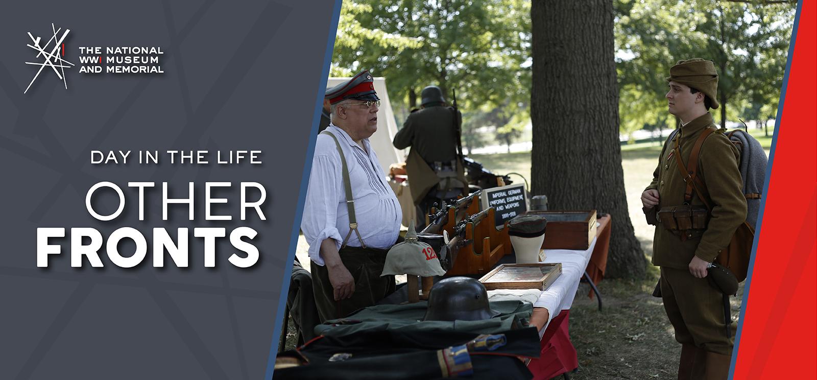 Text: 'Day in the Life / Other Fronts' Image: Older white man in shirtsleeves, suspenders and military cap talking to a younger white man in full WWI uniform across a table full of artifacts