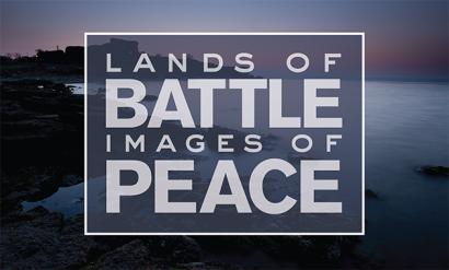 Background image: Sunrise scene of a bay in a sea coastline, lit in soft blues, oranges and pinks. Text: 'Lands of Battle / Images of Peace'